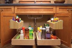 an open drawer in a kitchen filled with cleaning products