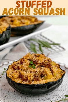 baked stuffed acorn squash in a black bowl on a white doily with text overlay