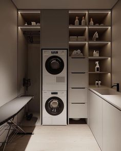 a washer and dryer in a room with shelves on the wall behind them