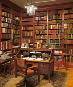 an old fashioned library with lots of books on shelves and a desk in the middle