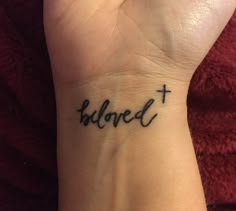 a woman's wrist with a tattoo that reads, believe