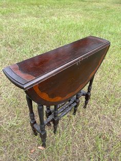 an old wooden table sitting in the grass