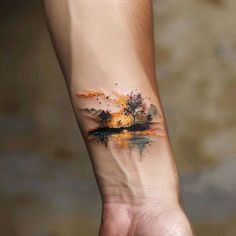 a person's arm with a tree tattoo on it