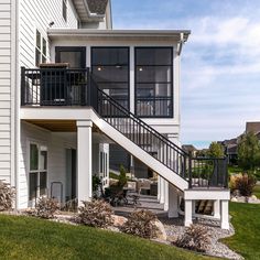 a white house with stairs leading to the second floor