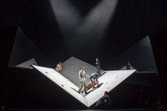 people standing on top of an upside down stage