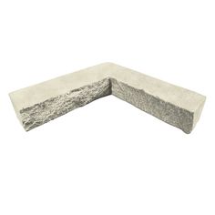 the corner of a stone bench is made out of concrete and has two different angles