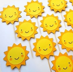 a bunch of little yellow sun lollipop sticks