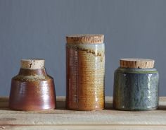 three vases sitting on top of a wooden table