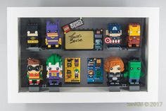 lego minifigures are arranged in a shadow box