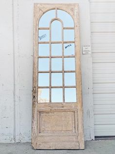 an old wooden door with a mirror on the front and side panels that say peace