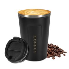 a black coffee cup next to some coffee beans and a grinder on a white background