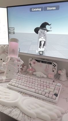 there is a computer monitor and keyboard on the desk in front of some stuffed animals