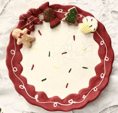 a red and white plate topped with different types of food on top of a table