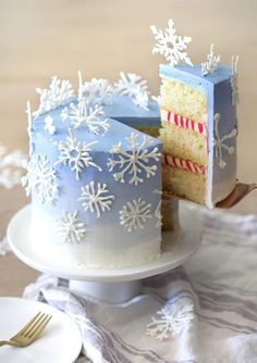 a frosted cake on a plate with a slice cut out and ready to be eaten