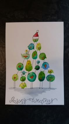 a christmas card with birds on top of each other and the words aaron's greetings written below