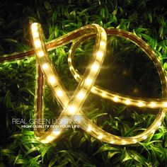 led strip light in the shape of x on top of green grass with words real green lighting high quality for your life