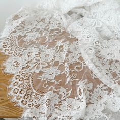 an image of white lace on a wooden table