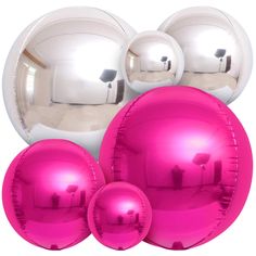 three shiny pink balls are next to each other