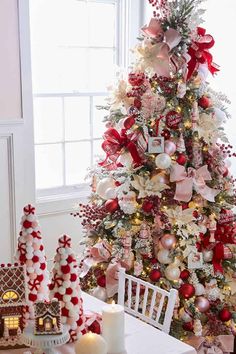 a christmas tree decorated with red, white and pink ornaments