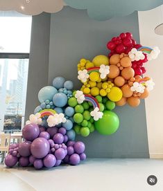 balloons are arranged in the shape of flowers and rainbows on display at an art gallery