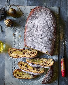 a loaf of bread sitting on top of a cutting board next to other food items