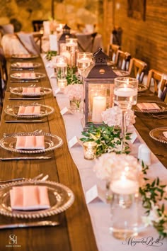 a long table with candles and plates on it