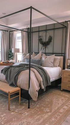 a bedroom with four poster bed and white linens on the pillows, along with an extra work area