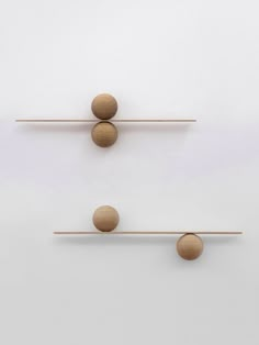 three wooden balls are placed on top of each other in the same direction as one ball