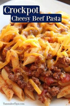 crockpot cheesy beef pasta on a white plate with text overlay