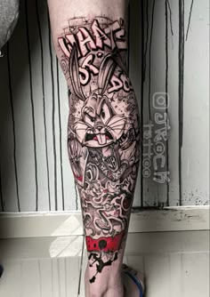 a man's leg with some tattoos on it