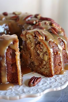 a bundt cake with pecans and caramel drizzled on top