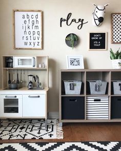 a playroom with toys, bookshelves and pictures on the wall above it