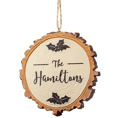 a wooden ornament hanging from a string with the words, the hamiltons on it