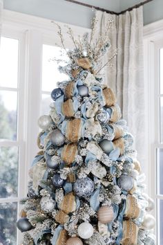 a christmas tree decorated with blue and gold ornaments