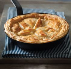 a pie sitting on top of a blue and white towel