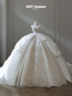 a wedding dress on display in front of a white wall with the words hey couture