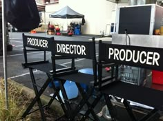 two director chairs sitting next to each other in front of a sign that says product