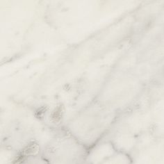 a white marble textured background with black and grey details on the top right corner