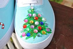 a pair of blue shoes decorated with candy canes and christmas tree decorations on them