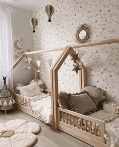 a room with two beds and pillows on the floor, one is made out of wood