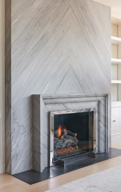 a fireplace in a living room next to a book shelf