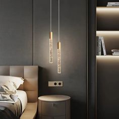 a bed room with a neatly made bed and two lights hanging from the headboard