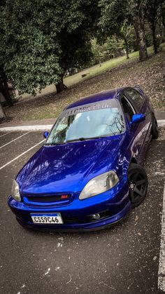 a blue car parked in a parking lot