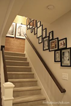 the stairs are lined with pictures and frames