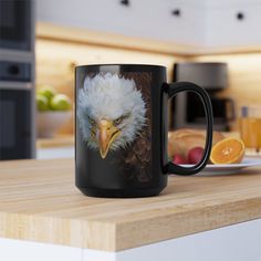 an eagle mug sitting on top of a kitchen counter next to orange slices and fruit