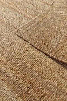 a close up view of a rug with some brown and tan colors on it's surface