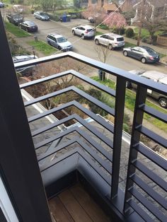 a balcony with cars parked on the street