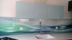 a kitchen counter with a sink, stove and cabinets in the back drop off area