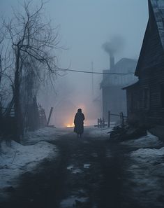 a person walking down a road in the snow