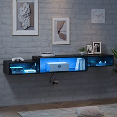 an entertainment center in the middle of a room with pictures on the wall behind it